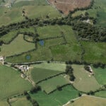 Birds-eye render of Harrogate Habitat Bank with habitats restored, including new meadows, trees, scrub, grassland, native hedgerow, broadleaved woodland, and ponds.