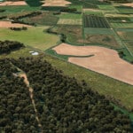Birds-eye render of Dersingham Habitat Bank with habitats restored, including new reedbeds, ponds, scrub, and grassland close to the Norfolk coastline