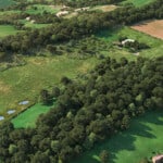 Birds-eye render of Martley Habitat Bank with habitats restored, including new meadows, scrub, grassland, orchards, ponds, native hedgerow, and trees