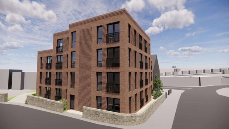 Render of JEM Developments' new housing complex, a four-storey building with dark brown bricks and large windows, surrounded by bushes and a small stone wall.
