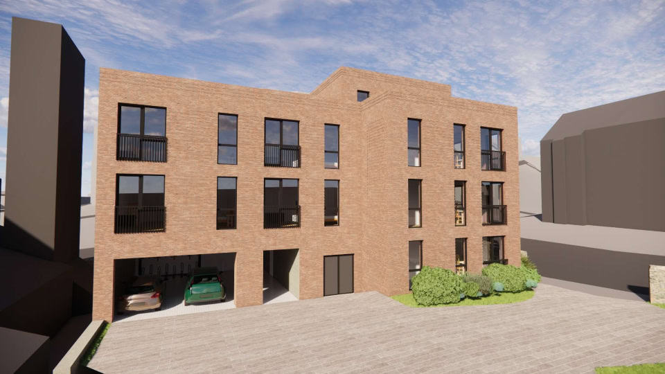 Render of JEM Developments' new housing complex, a four-storey building with light brown bricks and large windows with residents' parking spaces on the ground floor.