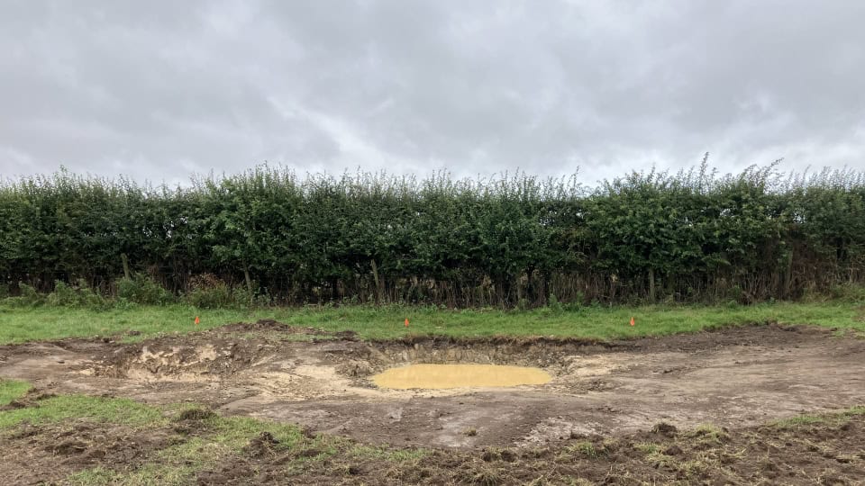 Recently dug pond at Heighington Habitat Bank beside some native hedgerow