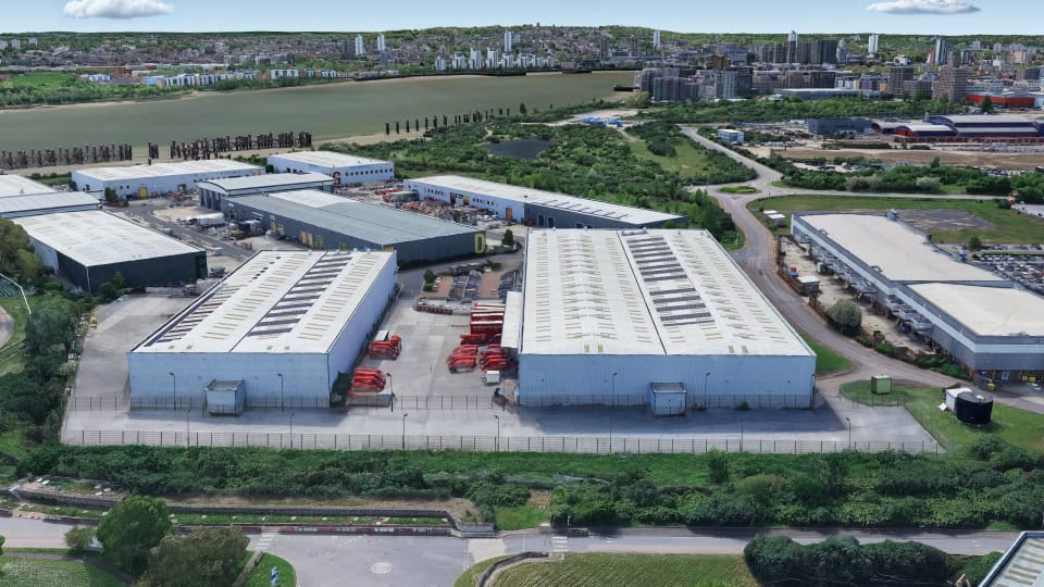 Aerial image of Gemini Business Park, two large warehouses surrounded by hedges and roads in an urban area with the London skyline on the horizon.